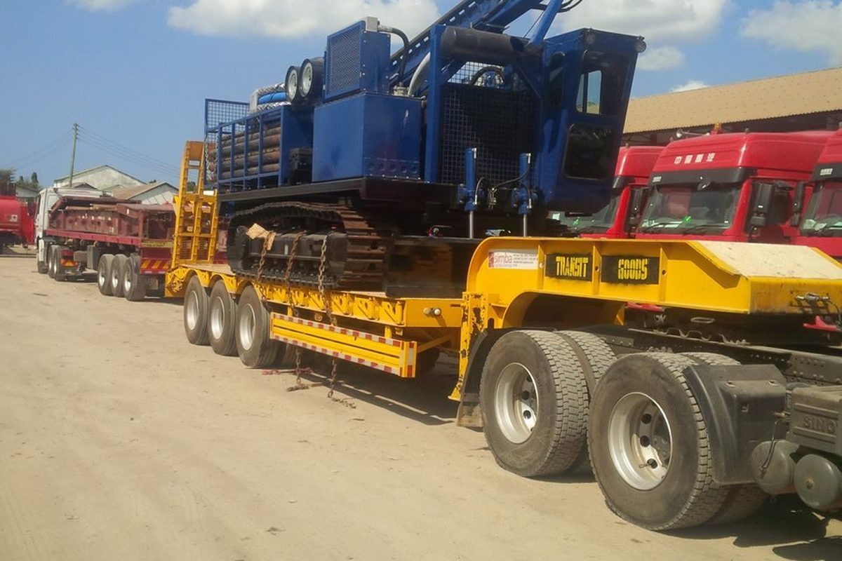 Low bed trailer transporting heavy equipment